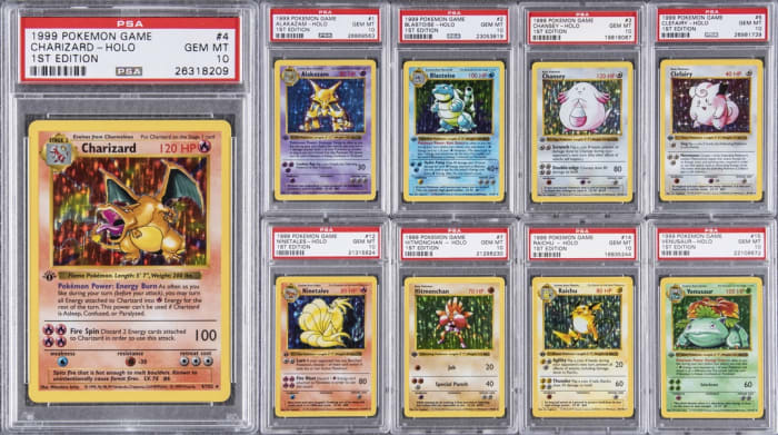 Some of the cards in the record-breaking 1999 Pokemon 1st Edition PSA GEM MT 10 set of 103, featuring #4 Charizard.