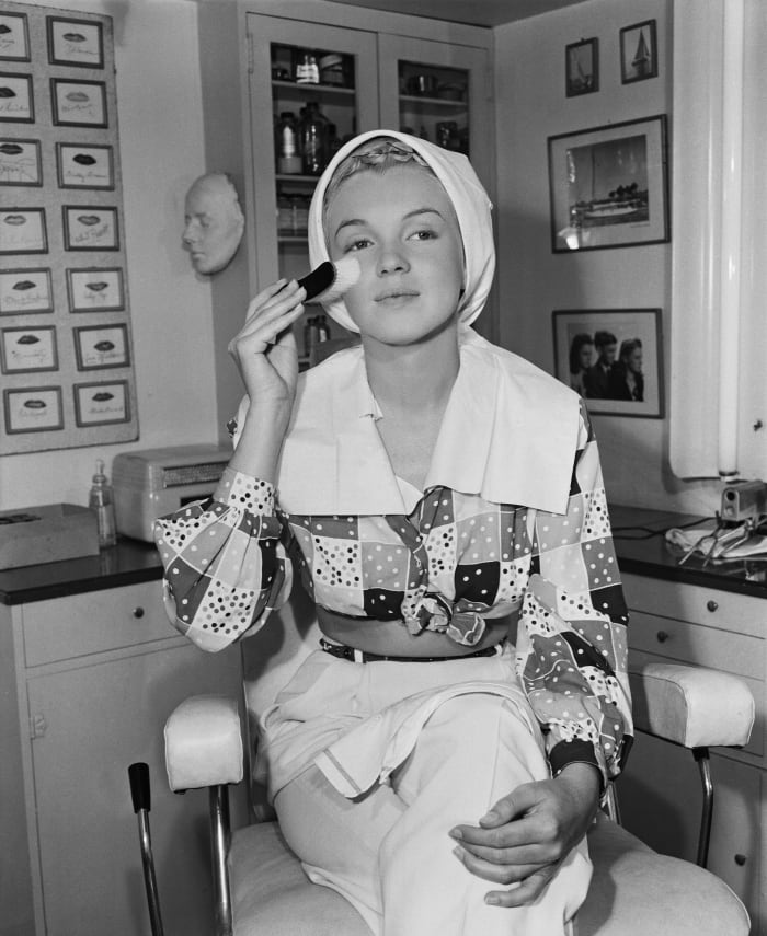 Marilyn Monroe begins her skin-care routine before applying her makeup.